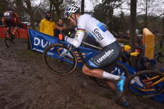 Mathieu van der Poel runs through the mud