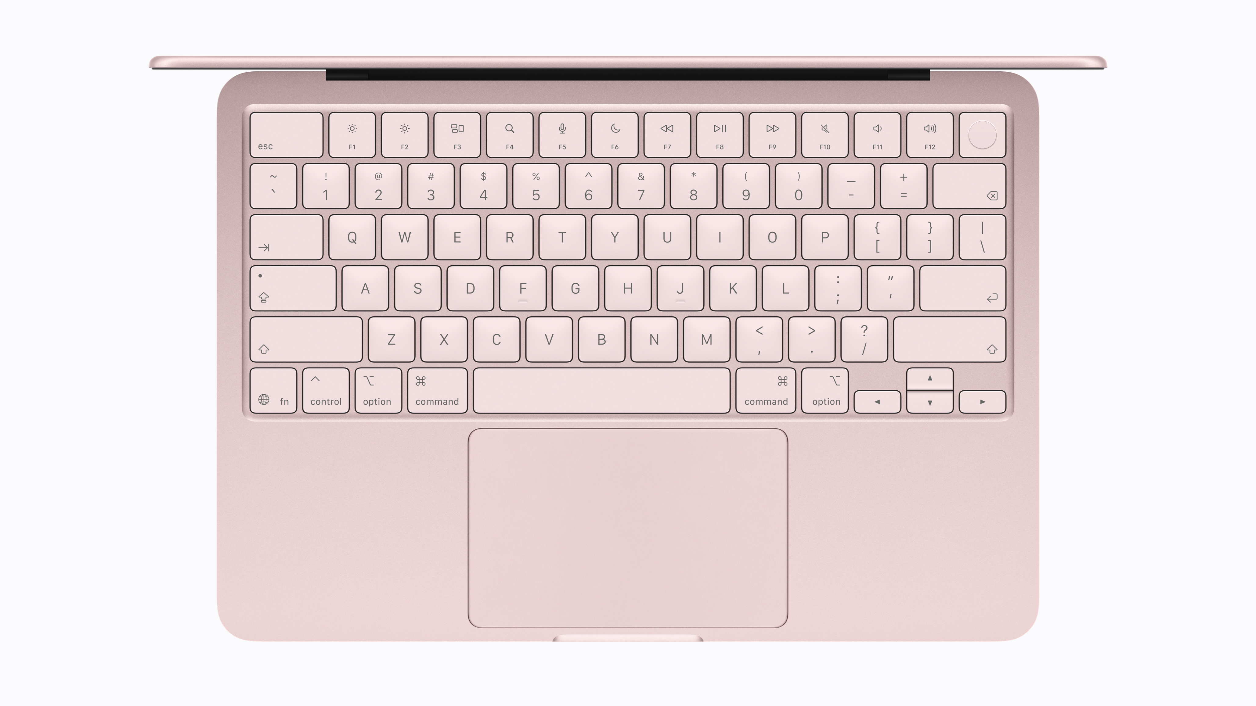Top-down view of the Apple MacBook Neo keyboard and large trackpad in pink finish.