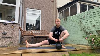 Fit&Well fitness writer Harry Bullmore performing an assisted Cossack squat
