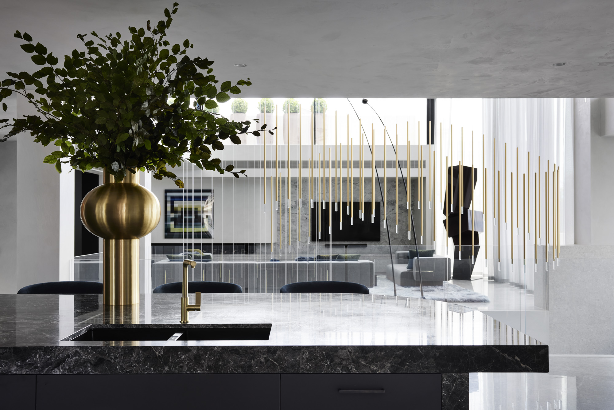 kitchen looking beyond to dining and living area at Curatorial House in Melbourne