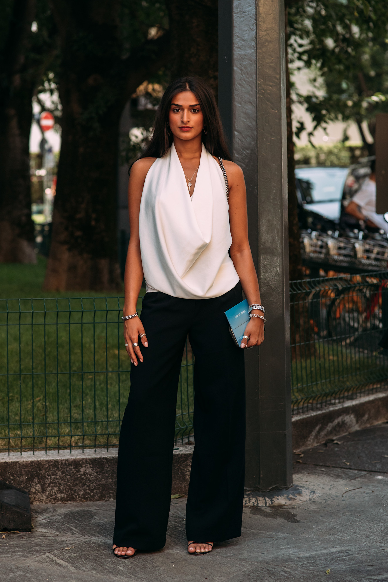 Milan Mens Fashion Week showgoer wears a halterneck top with trousers in Milan