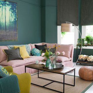 green living room with pink sofa
