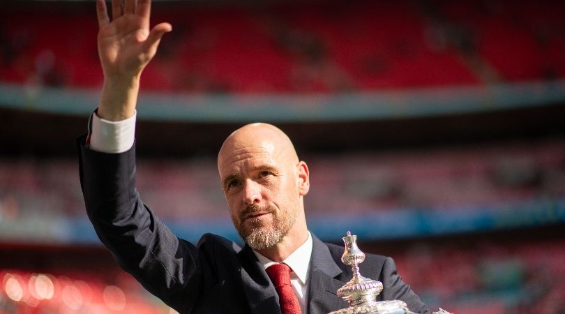 Erik ten Hag waves to Manchester United fans while holding the FA Cup after victory in the final over Manchester City in May 2024.