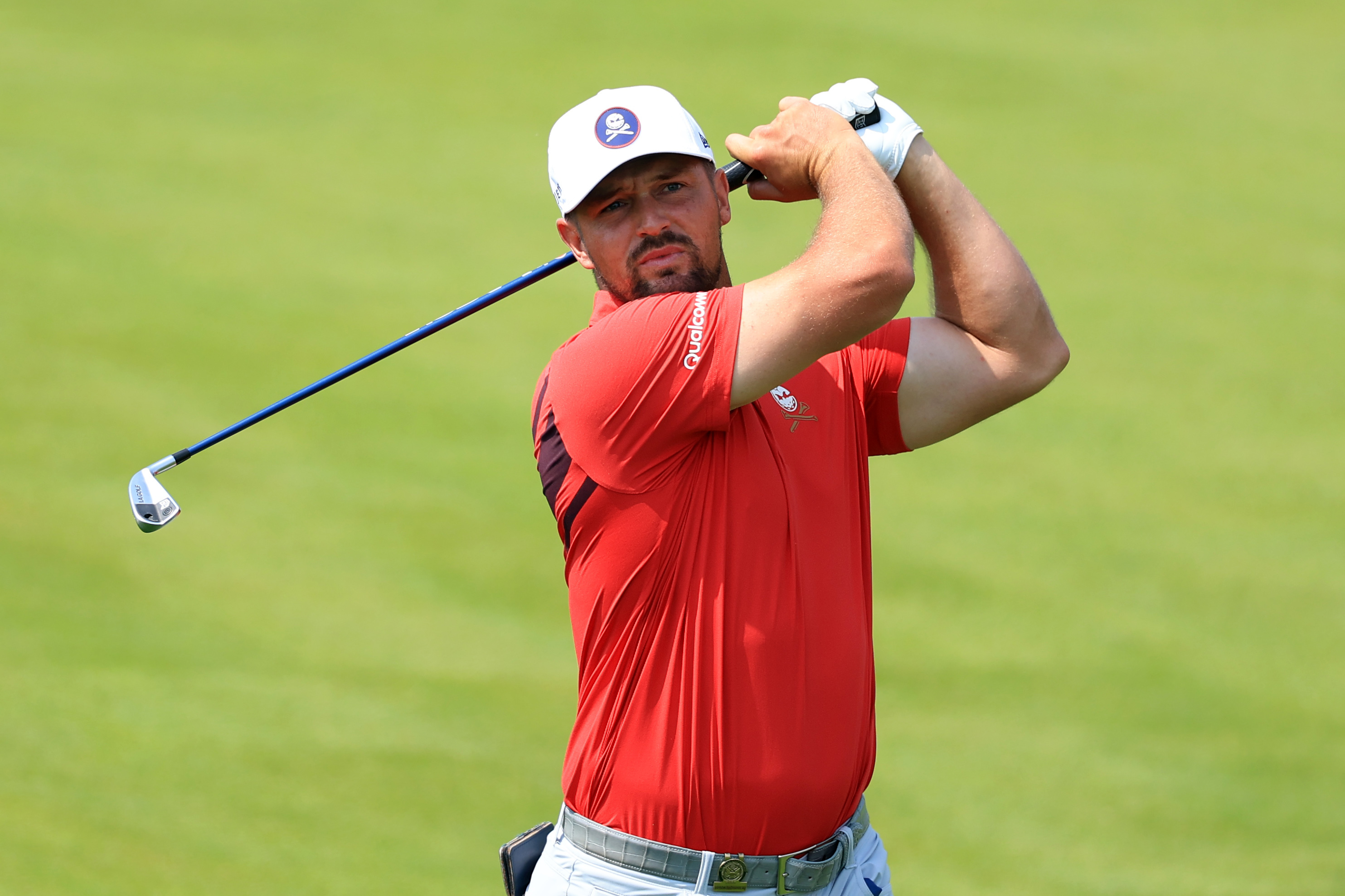 Bryson DeChambeau hits an iron from the fairway