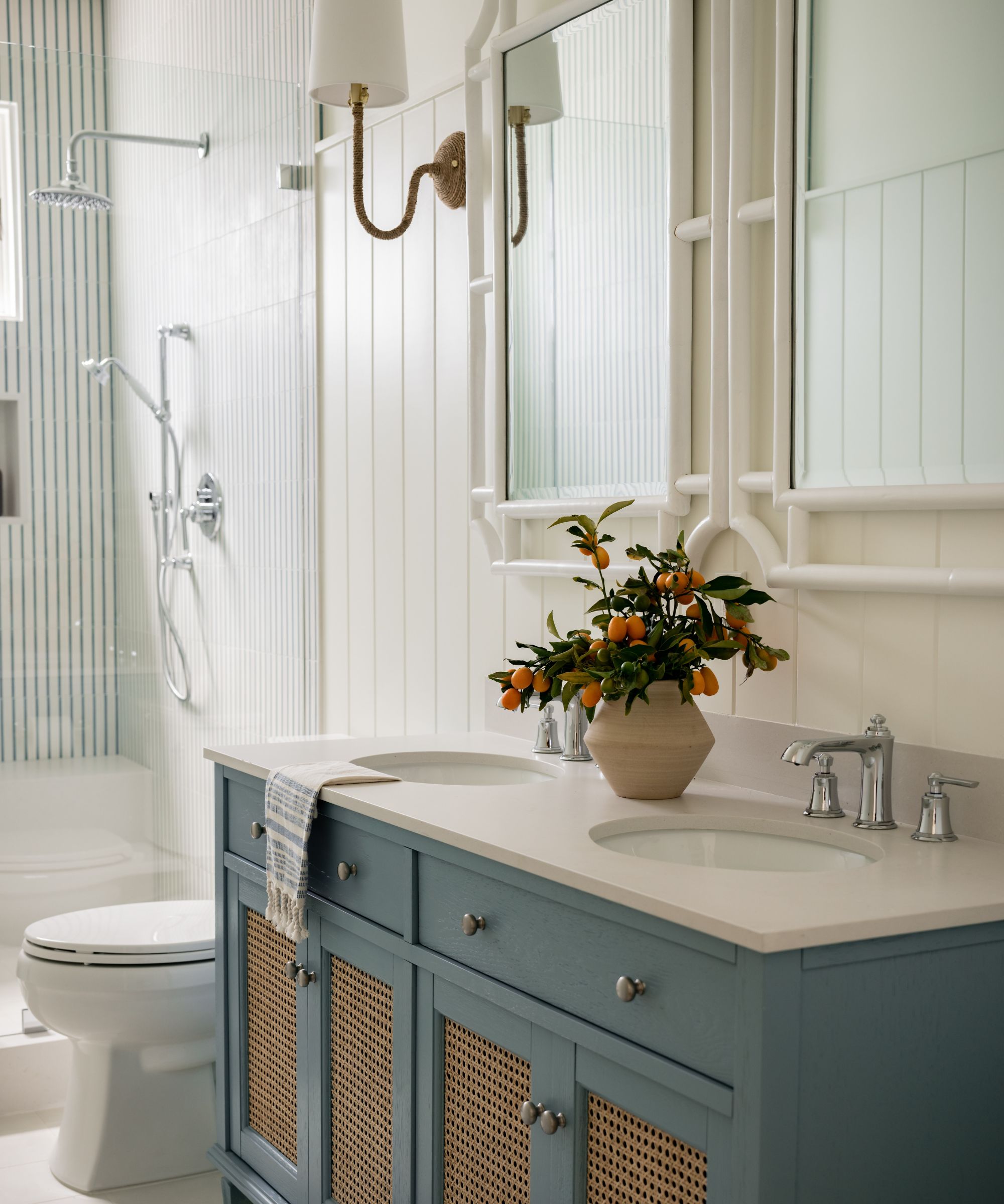 striped shower in a neutral blue and white bathroom with panelling