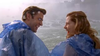 Jim and Pam smiling and wearing raincoats in front of Niagara Falls in The Office