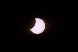 The moon partially covers the sun during a total solar eclipse as seen from Piedra del Aquila, Neuquen province, Argentina on December 14, 2020.
