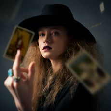 woman with tarot cards in the air