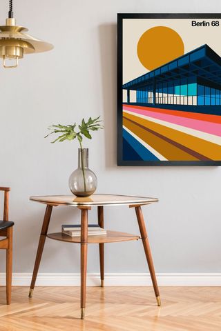 colourful artwork on wall with wooden table and pendant lamp