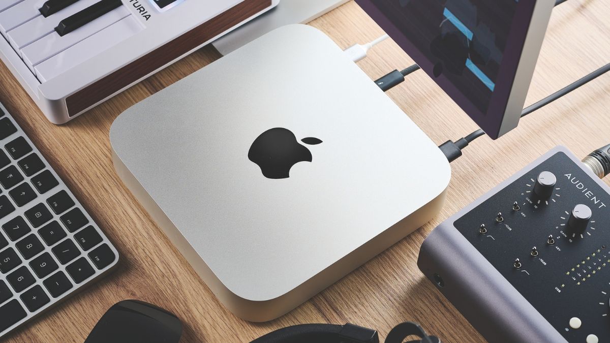 A Mac Mini M2 on a studio desk with MIDI keyboard and audio interface