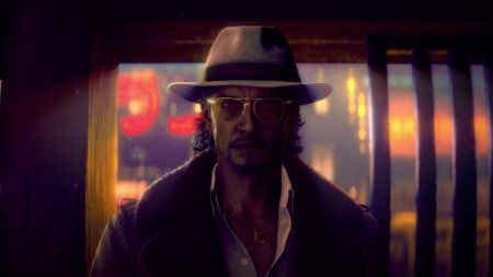 An older Makoto wars a hat and glasses, with neon lights behind him in Stranger Than Heaven