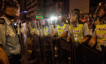 Hong Kong police in riot gear monitor protesters