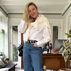 Erin Walsh wears a white shirt and jeans