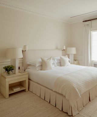 white bedroom with all white tones and tab pleated bed skirt