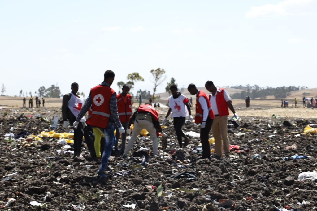 Rescuers look through the Ethiopian Airlines crash site.