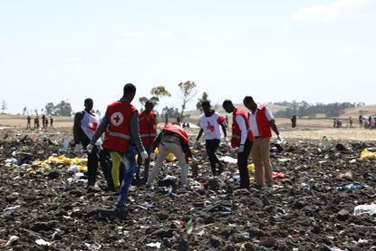 Rescuers look through the Ethiopian Airlines crash site.