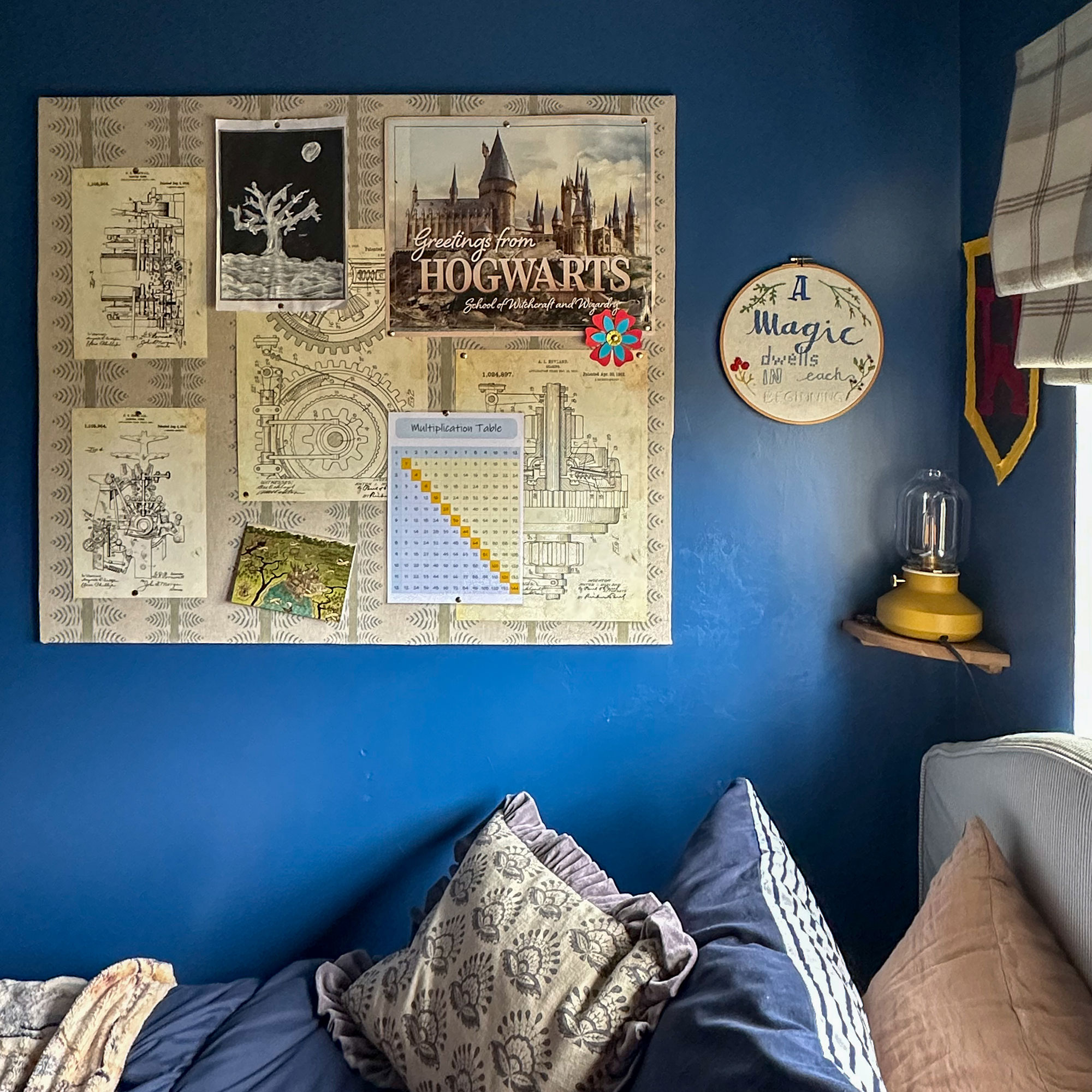 Blue boy's bedroom with pinboard above bed decorated with Harry Potter posters