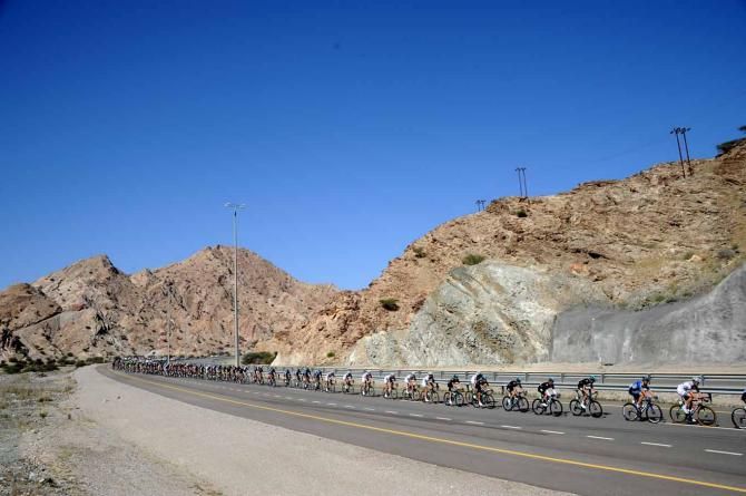 The peloton in the scenic surrounds of Oman.