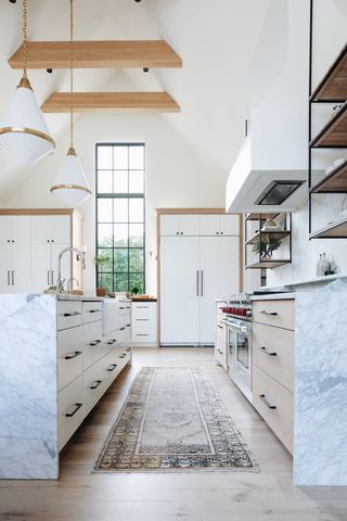 modern scandinavian-style kitchen with marble island and floor runner and exposed ceiling beams