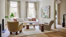 Neutral tone rug and accent chairs in a modern home