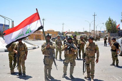 Iraq forces celebrate after retaking the town of Rutba from ISIS