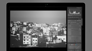 City skyline in a Lightroom preset on a MacBook screen