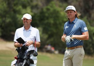 Cameron Smith and his caddie discuss a golf shot