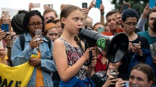 Swedish youth climate activist Greta Thunberg delivers brief remarks surrounded by other student environmental advocates during a strike against climate change outside the White House on September 13, 2019 in Washington, DC. The strike is part of Thunberg's six day visit to Washington ahead of the “Global Climate Strikes” on Friday September 20.