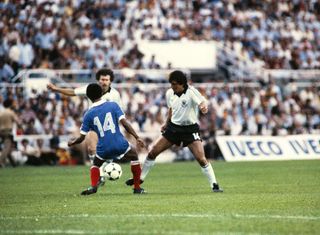 French midfielder Jean Tigana (back view) vies with West German players during the 1982 World Cup semifinal football match between West Germany and France on July 8, 1982 in Seville.