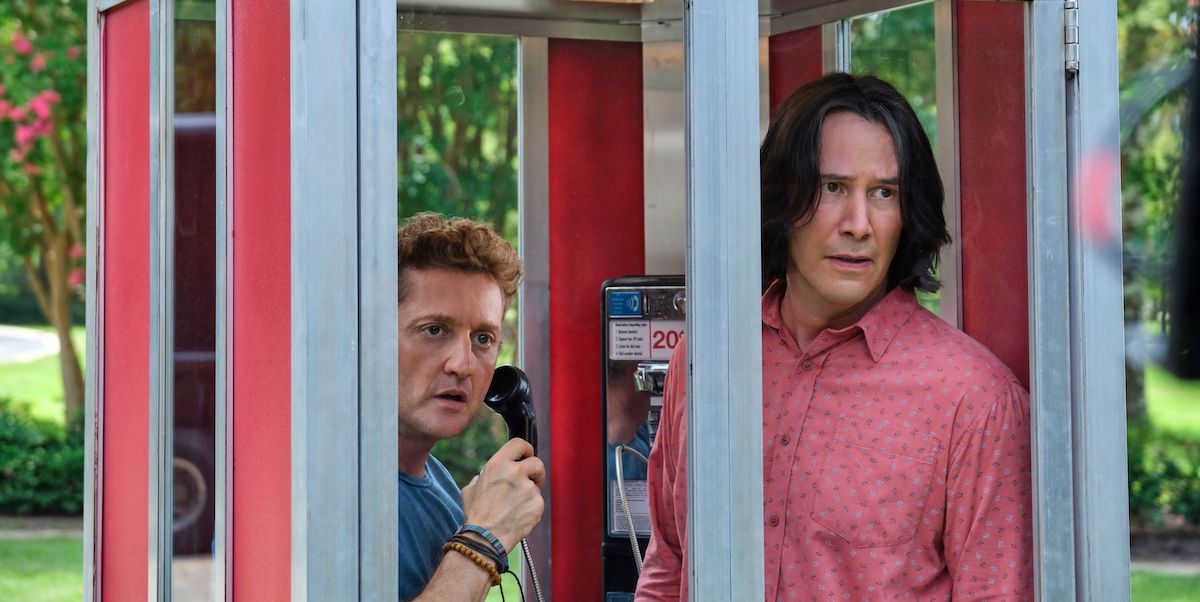 Bill (Alex Winters) holds a telephone as he stands need to Ted (Keanu Reeves) in a booth in &#039;Bill and Ted Face the Music&#039;