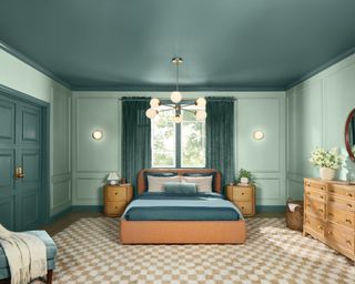 teal blue bedroom with beige checked rug and wooden furniture