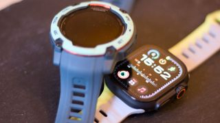 Garmin Instinct 3 next to the Apple Watch Ultra 2