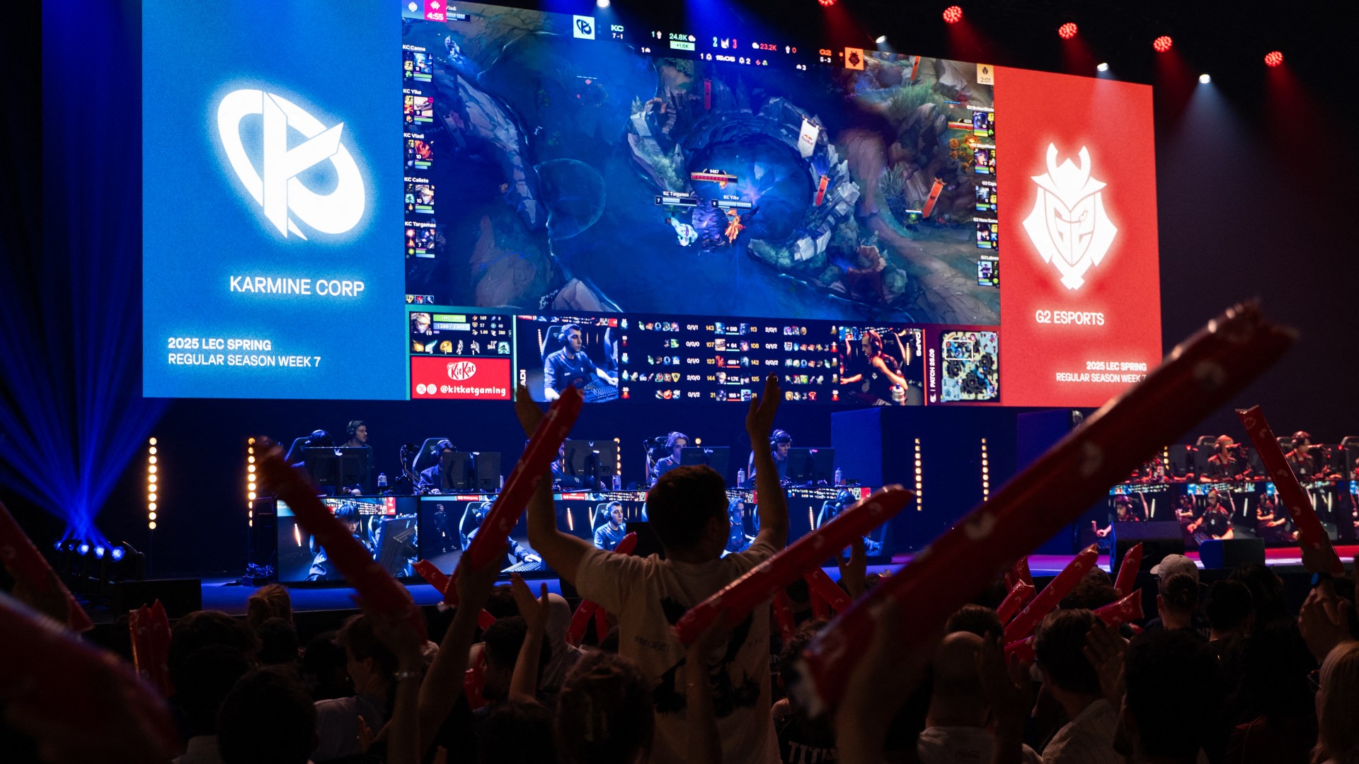 Supporters cheer as Karmine Corp's players (L) compete against the G2 eSports' players in the League of Legends EMEA Championship