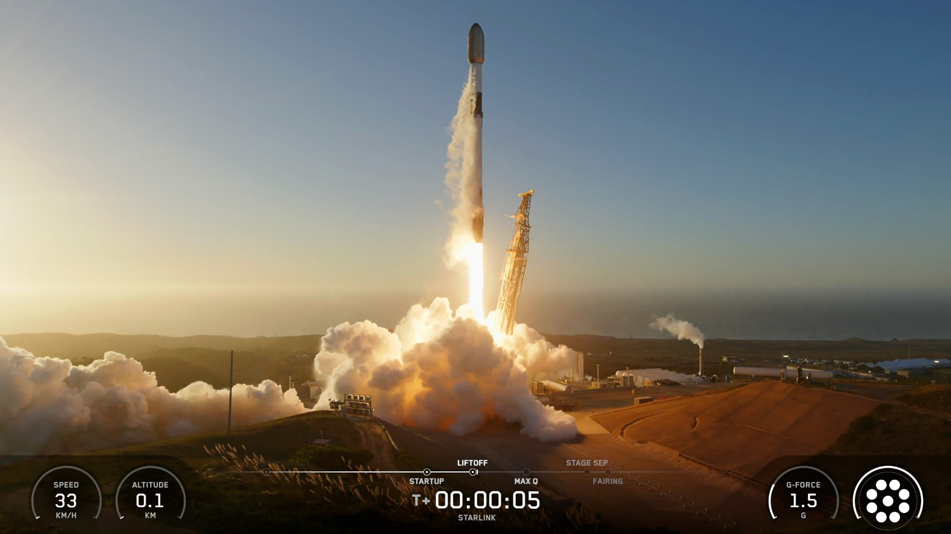 a black and white rocket launches from a seaside pad