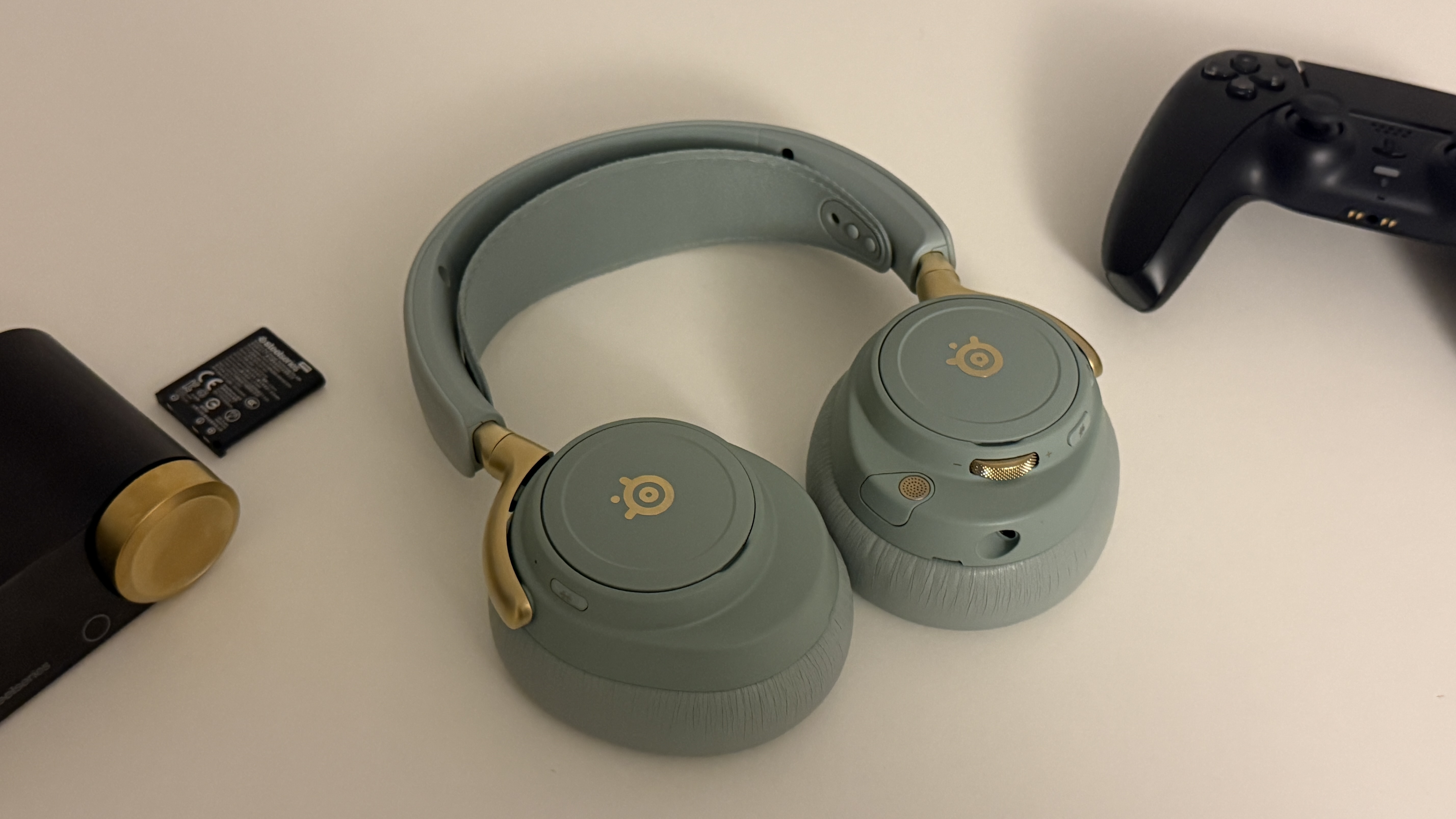 A pair of Sage Green SteelSeries Arctis Nove Elite in various set ups