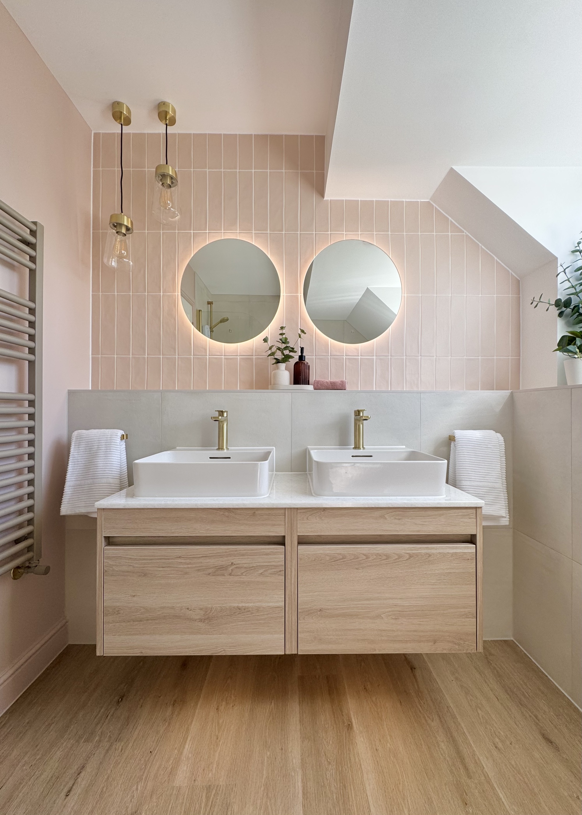 A Scandi-style bathroom with pink zellige tiles and a double vanity