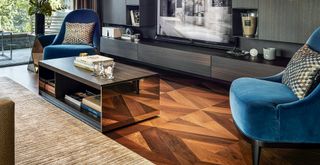 Luxe look living room with diamond patterned wooden flooring trend and bespoke built in entertainment unit