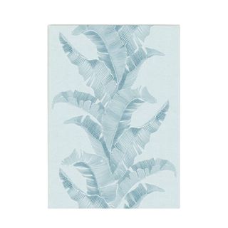 A blue rug with a palm leaf print