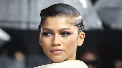 Zendaya attends the "Dune" UK Special Screening wearing purple eyeshadow on her brown eyes