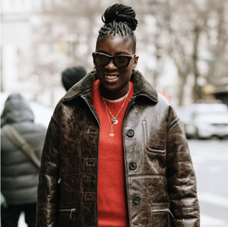 Nikki Ogunnaike wearing a red sweater and a leather jacket