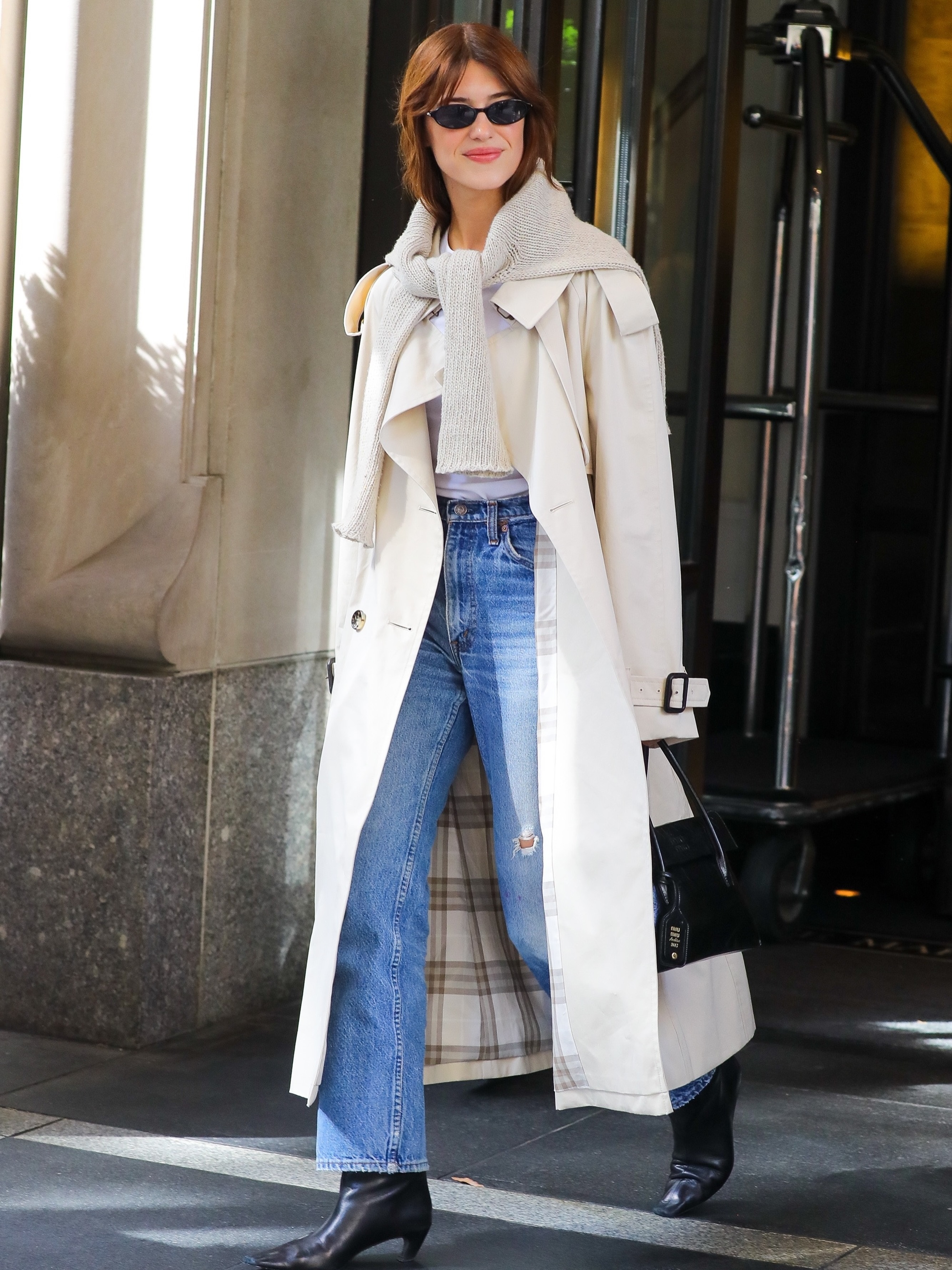 dani michelle shares a picture of Daisy Edgar Jones wearing a trench coat, jeans and ankle boots