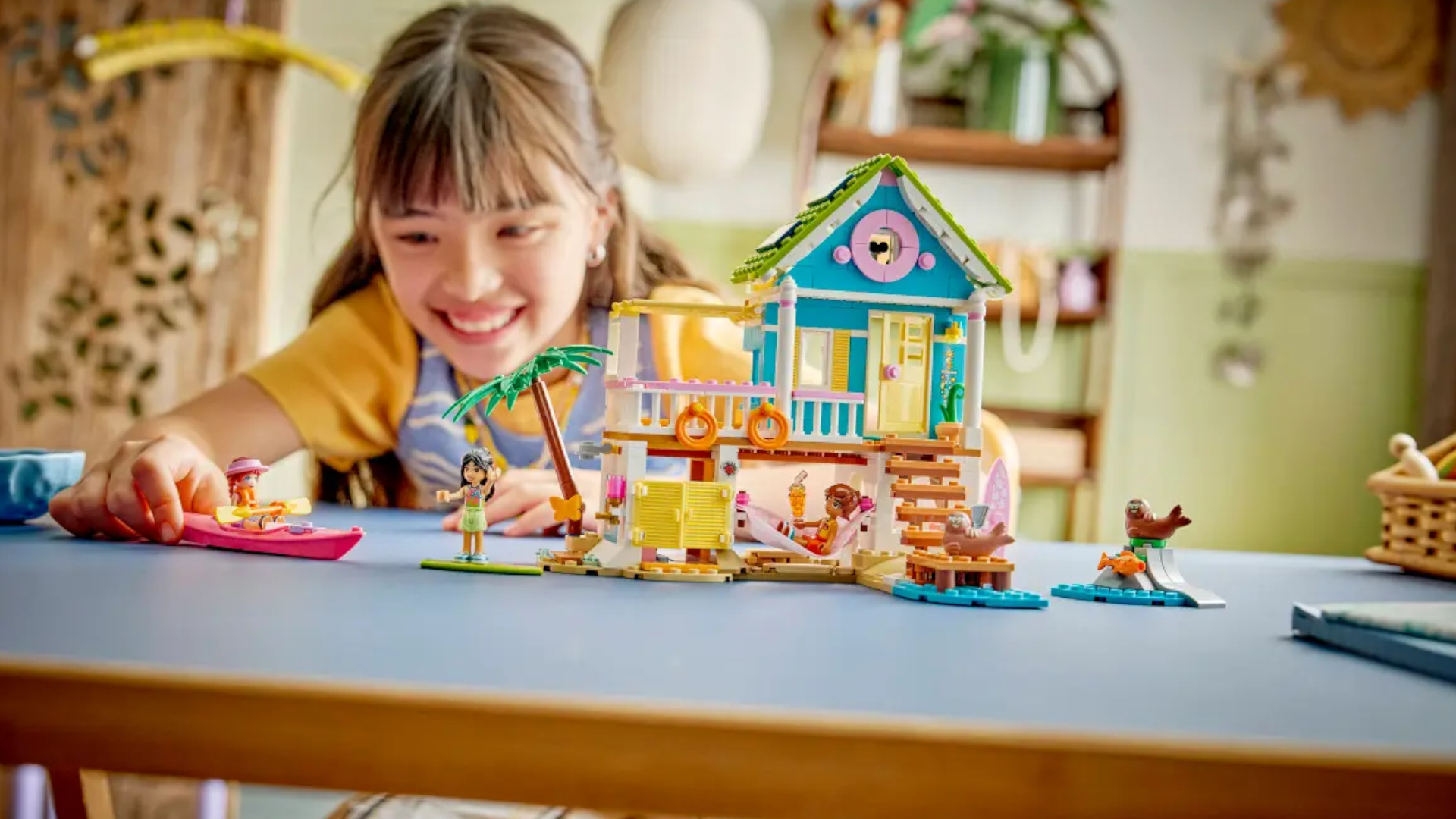 A child plays with a Lego beach house set