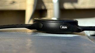 Side view of the Garmin Forerunner 265, showing the new wider "RUN" button