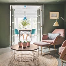 green living room with pink chairs