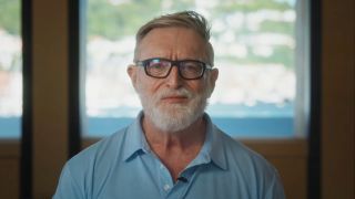 Gabe Newell in light blue shirt