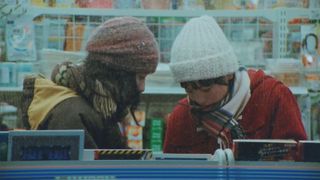 Fujino and Kyomoto huddling together in a Lawson convenience store in Look Back