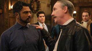 Pictured (L-R): Utkarsh Ambudkar as Jay looking scared and Matt Walsh as Elias Woodstone putting his hand on Jay's left shoulder while talking to him.
