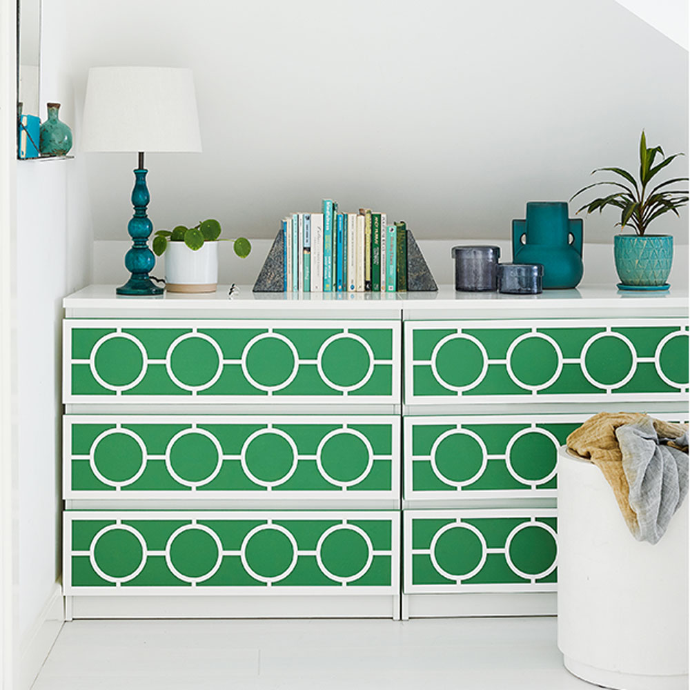 white room with green drawer and lamp