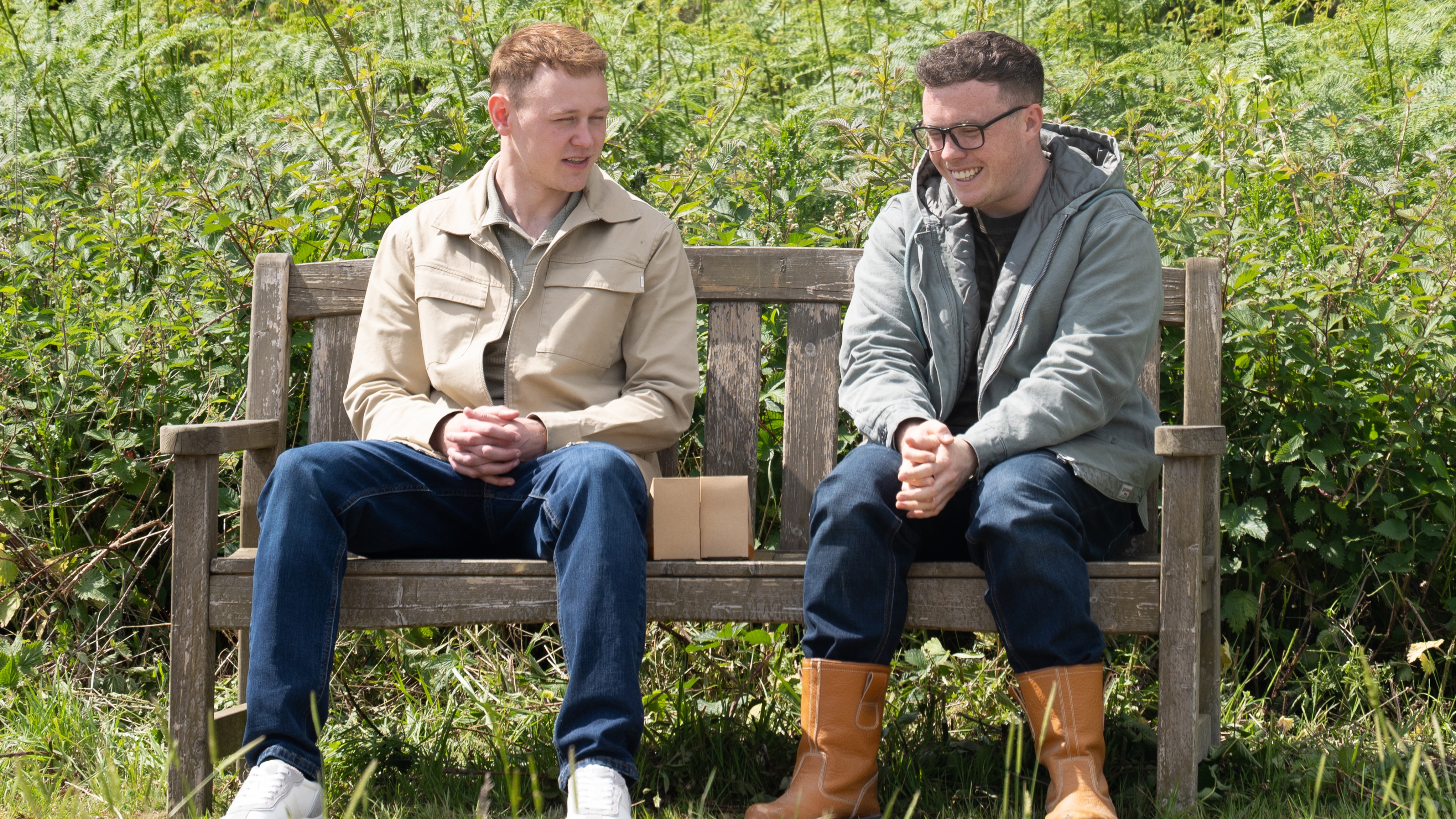 Mike and Vinny speak on a park bench