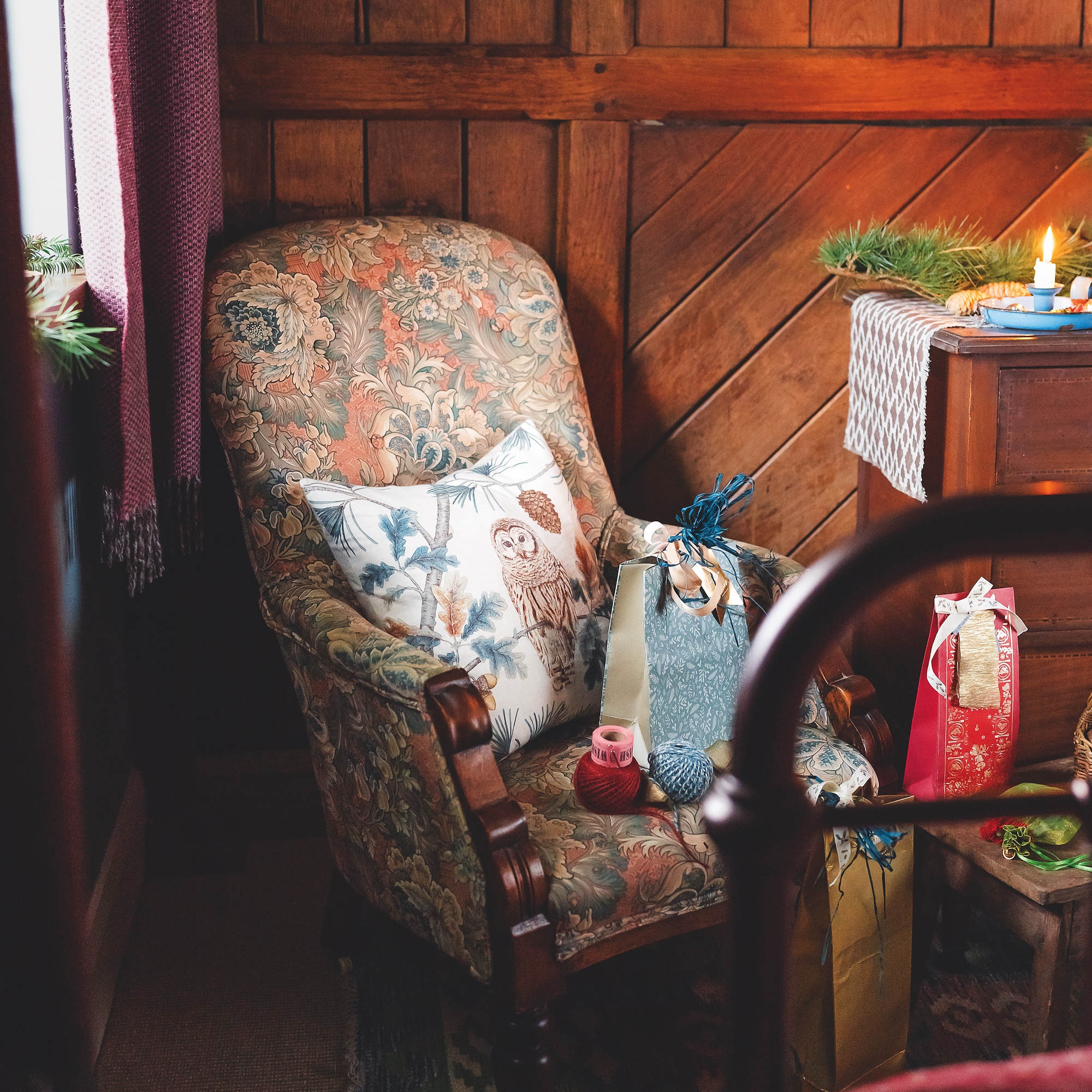 sitting room in coverted stables with wooden panel from stable stall and blue velvet sofa
